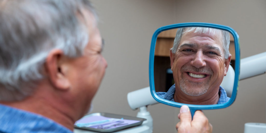 full arch dental implants patient smiling