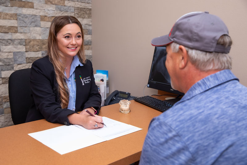 patient coordinator discussing the cost of dental implants