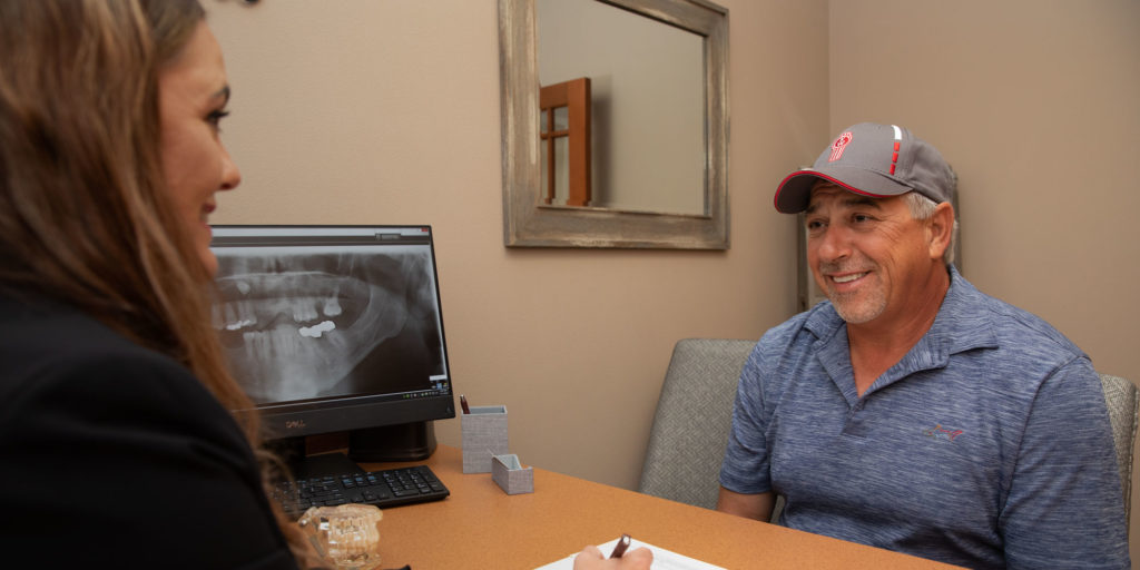 patient discussing the cost of dental procedure